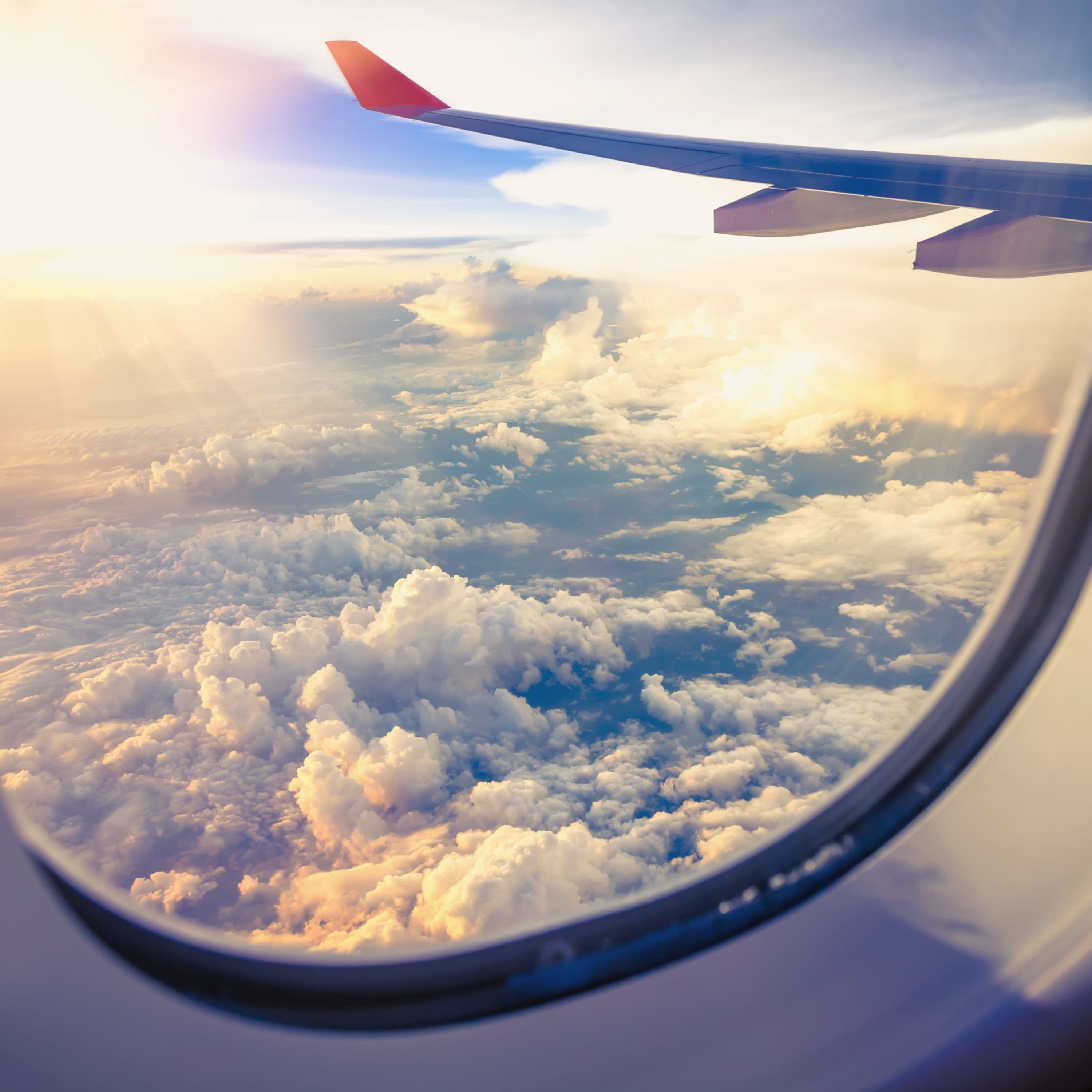 View from airplane window showing clouds and wing
